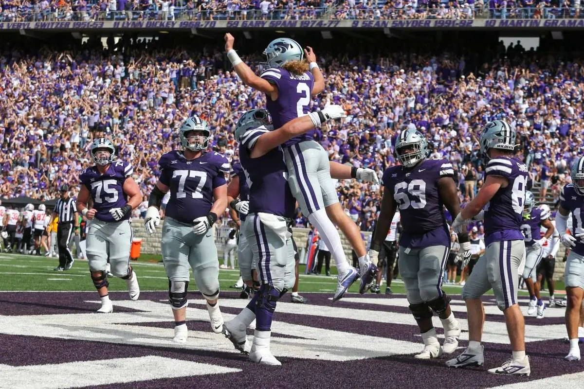 Sep 28, 2024; Manhattan, Kansas, USA; Kansas State Wildcats quarterback Avery Johnson (2) leaps into the arms of offensive lineman Hadley Panzer (54) after scoring a touchdown against the Oklahoma State Cowboys in the fourth quarter at Bill Snyder Family Football Stadium. Mandatory Credit: Scott Sewell-Imagn Images